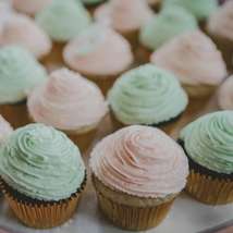 A plate of mint green and pink cupcakes by rod long